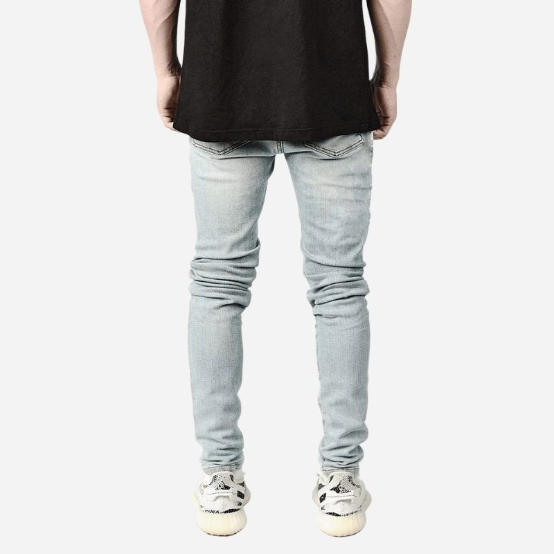 Men's ripped slim fit skinny jeans in light blue, back view