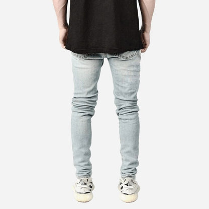 Men's ripped slim fit skinny jeans in light blue, back view