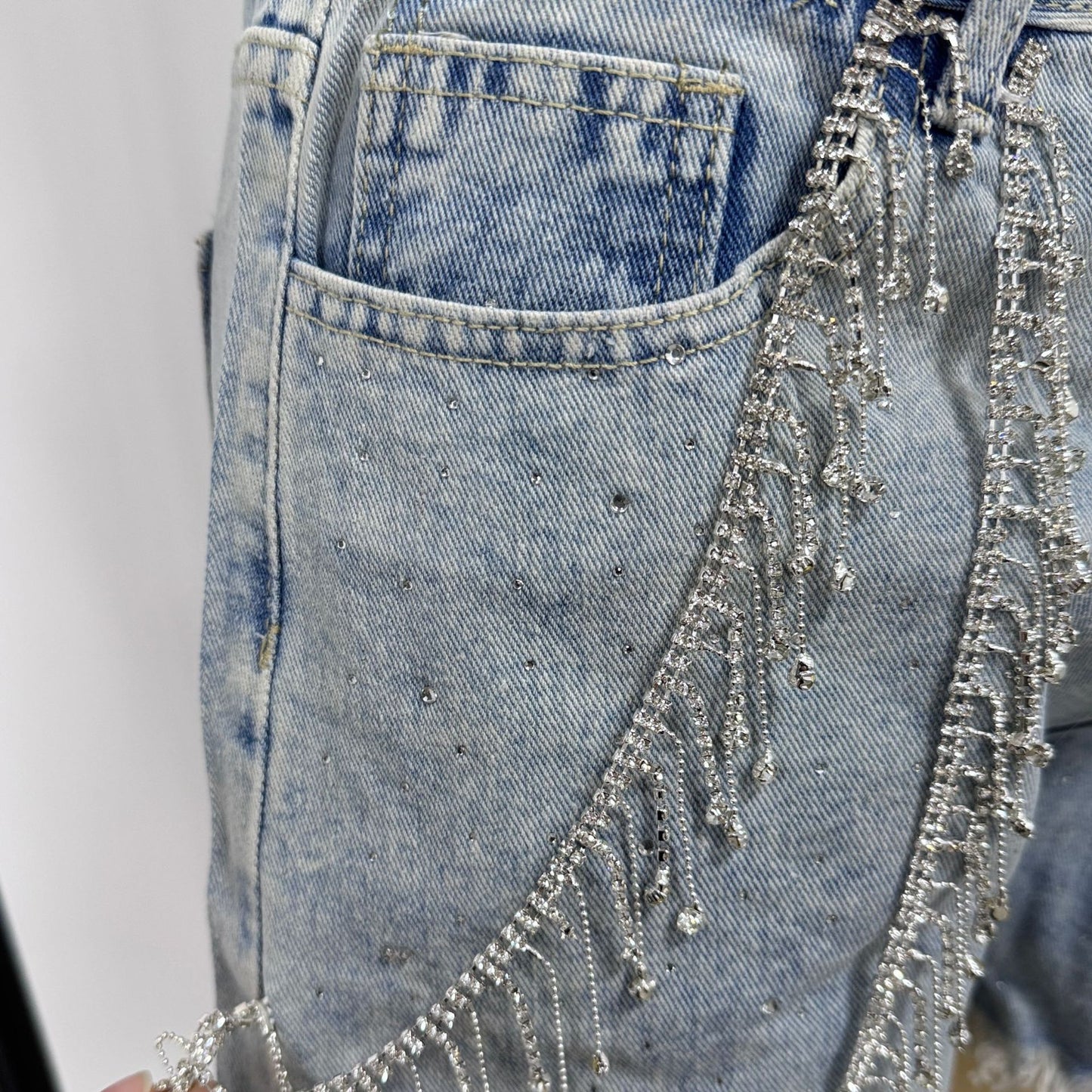 Women's rhinestone fringe chain denim shorts in blue, details view