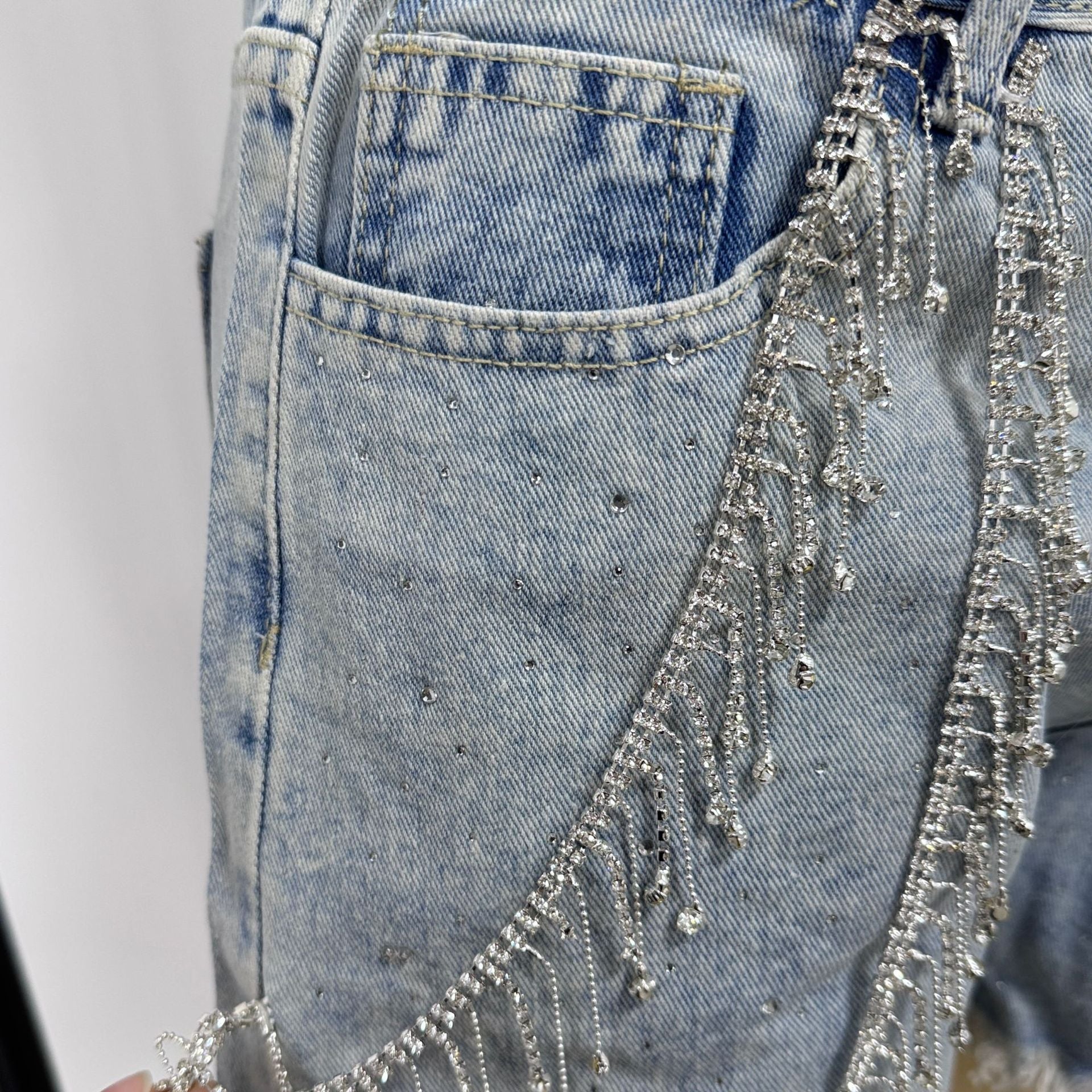Women's rhinestone fringe chain denim shorts in blue, details view