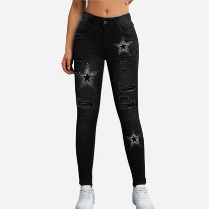 Women's ripped skinny jeans star print denim pants in black, front view