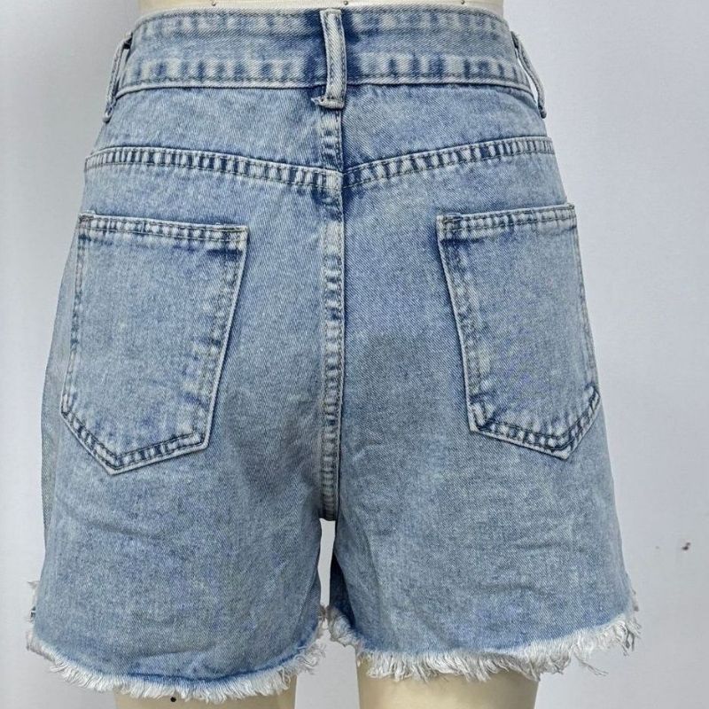 Women's rhinestone fringe chain denim shorts in blue, back view